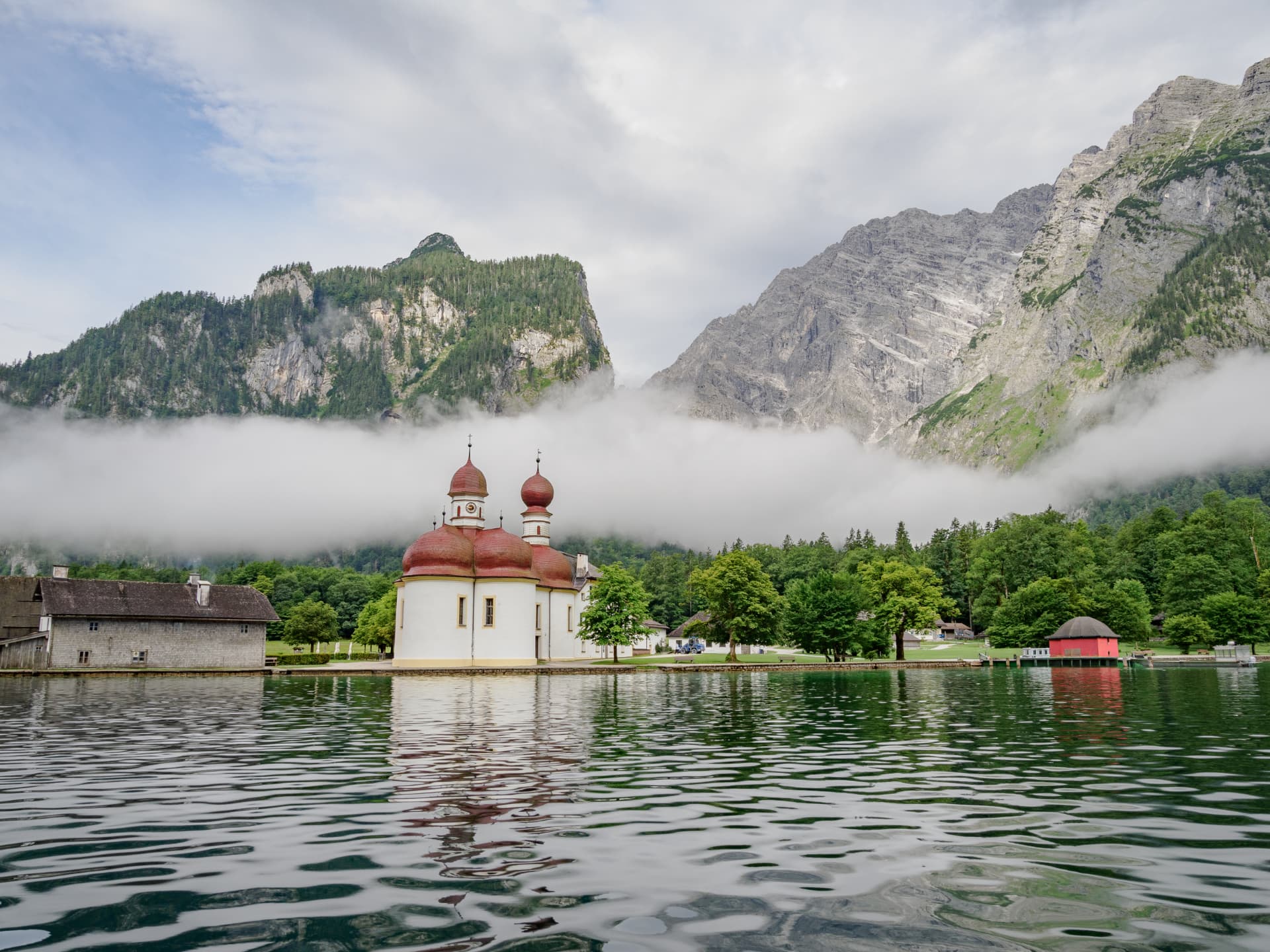 St. Bartholomew church beneath misty mountains