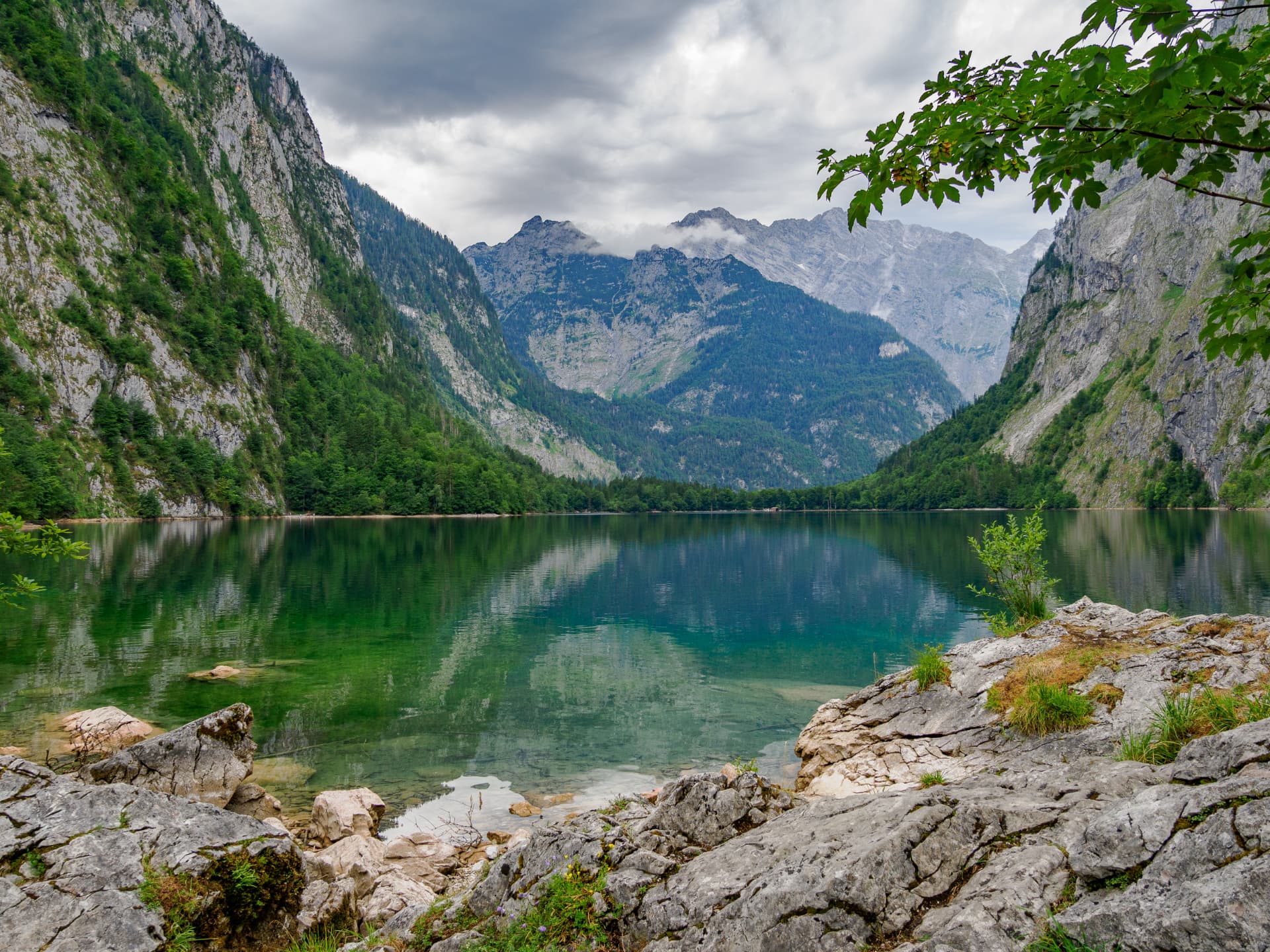 Turquoise mountain lake between steep forested walls